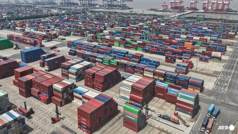 Shipping containers are stacked at a port in Shanghai on May 9, 2025. (Photo: STR/AFP)