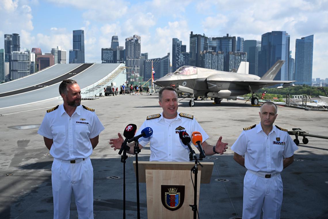 (From left) Captain Will Blackett, Commodore James Blackmore and Captain Colin McGannity speaking to the press on the flight deck of the British aircraft carrier HMS Prince of Wales, docked at the Marina Bay Cruise Centre.ST PHOTO: CHONG JUN LIANG