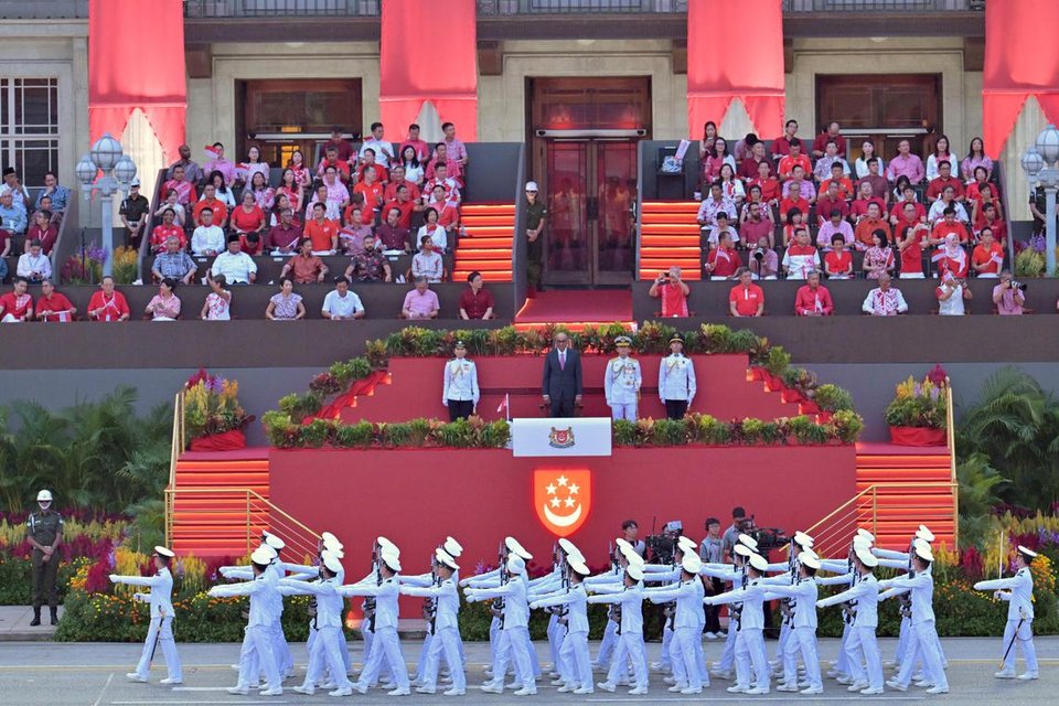 The Republic of Singapore Navy's guard-of-honour contingent marching before President Tharman Shanmugaratnam, as well as ministers and MPs in front of the former City Hall building.  ST PHOTO: DESMOND FOO
