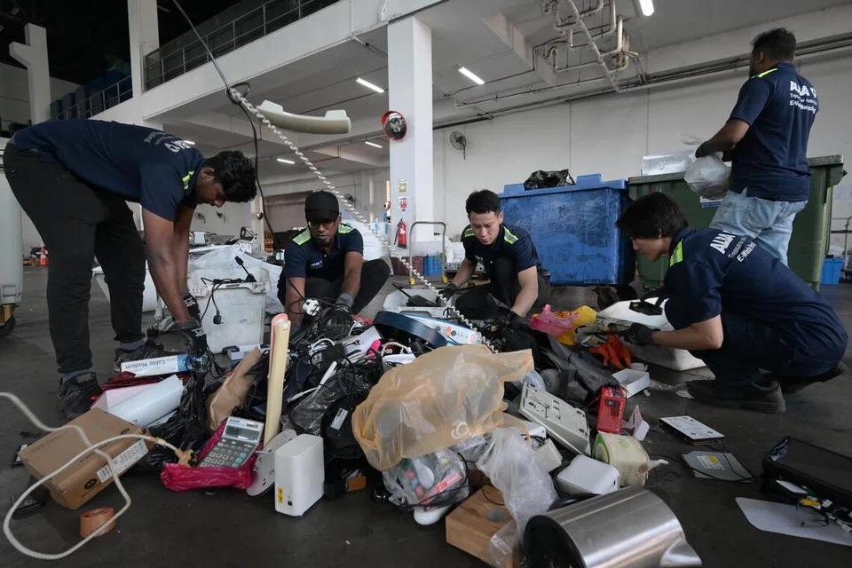 Collected e-waste is sorted at Alba E-Waste Smart Recycling's warehouse in Tuas.  ST PHOTO: NG SOR LUAN