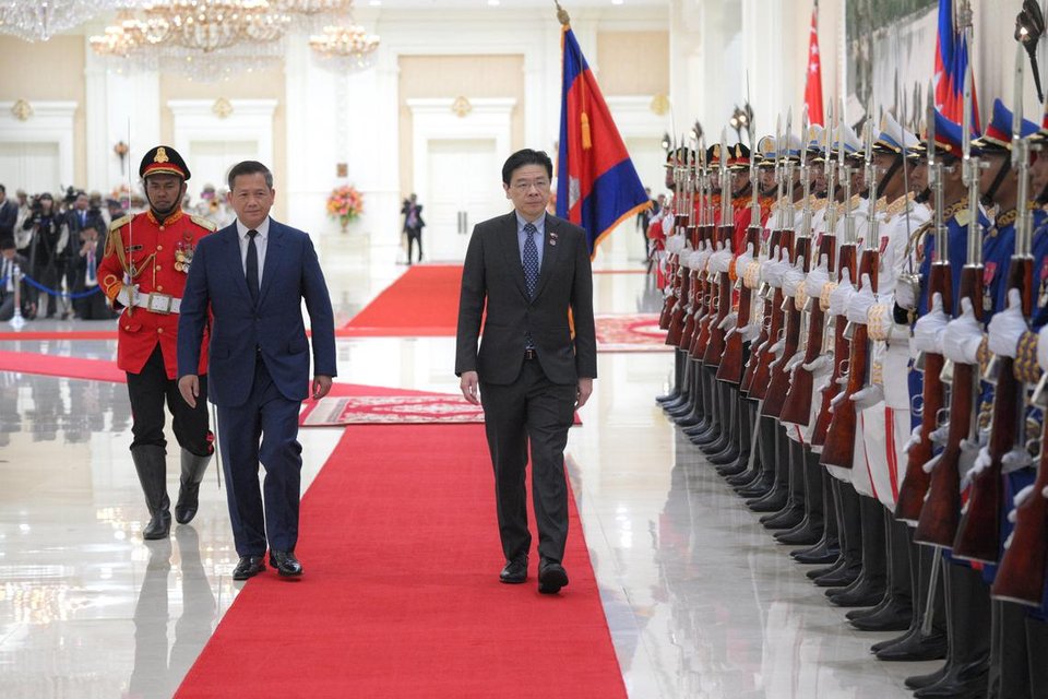 Prime Minister Lawrence Wong, accompanied by his Cambodian counterpart, Mr Hun Manet, inspecting the guard of honour during a welcome ceremony at the Peace Palace in Phnom Penh on July 2.  ST PHOTO: MARK CHEONG