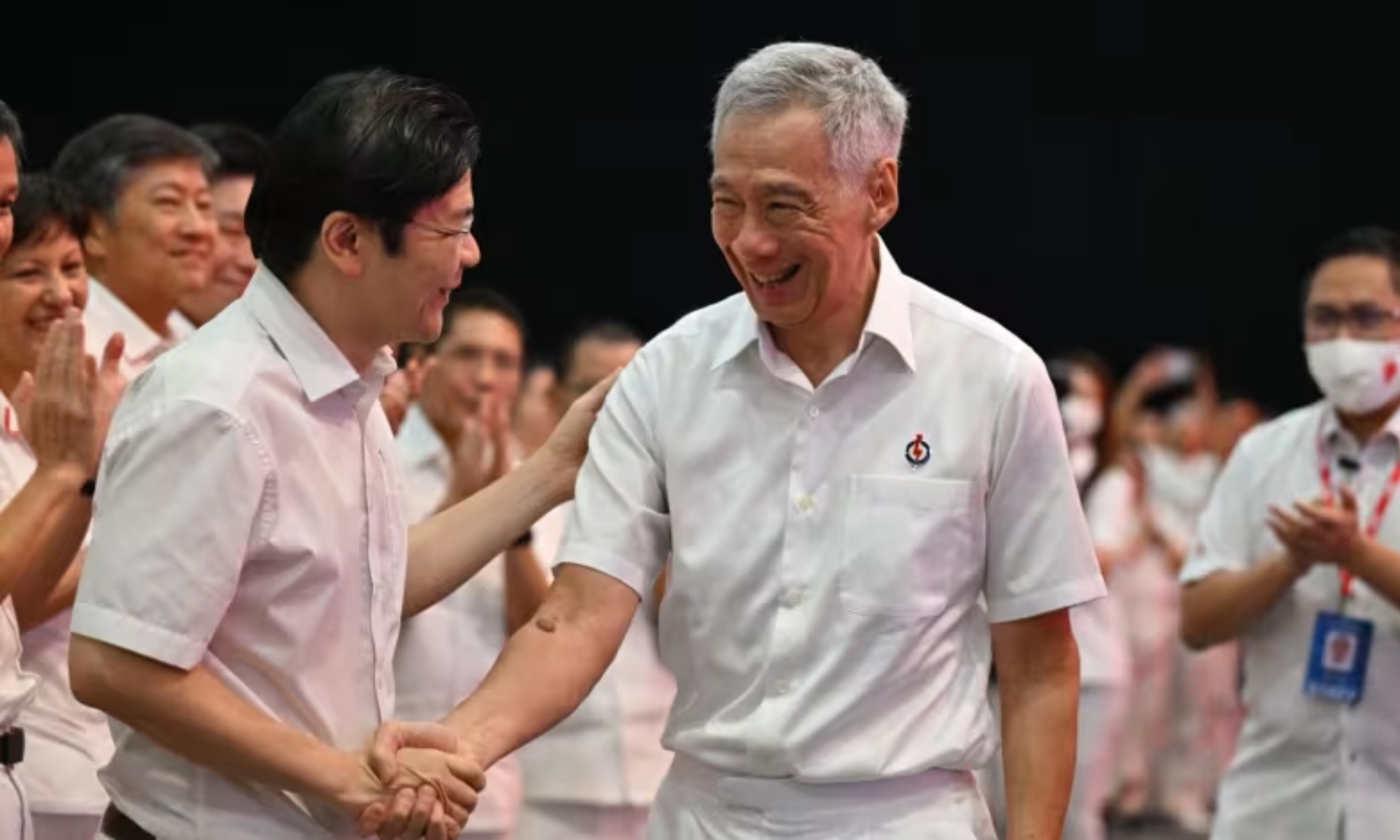 Singapore Prime Minister and People's Action Party secretary-general Lee Hsien Loong shakes hands with Deputy Prime Minister